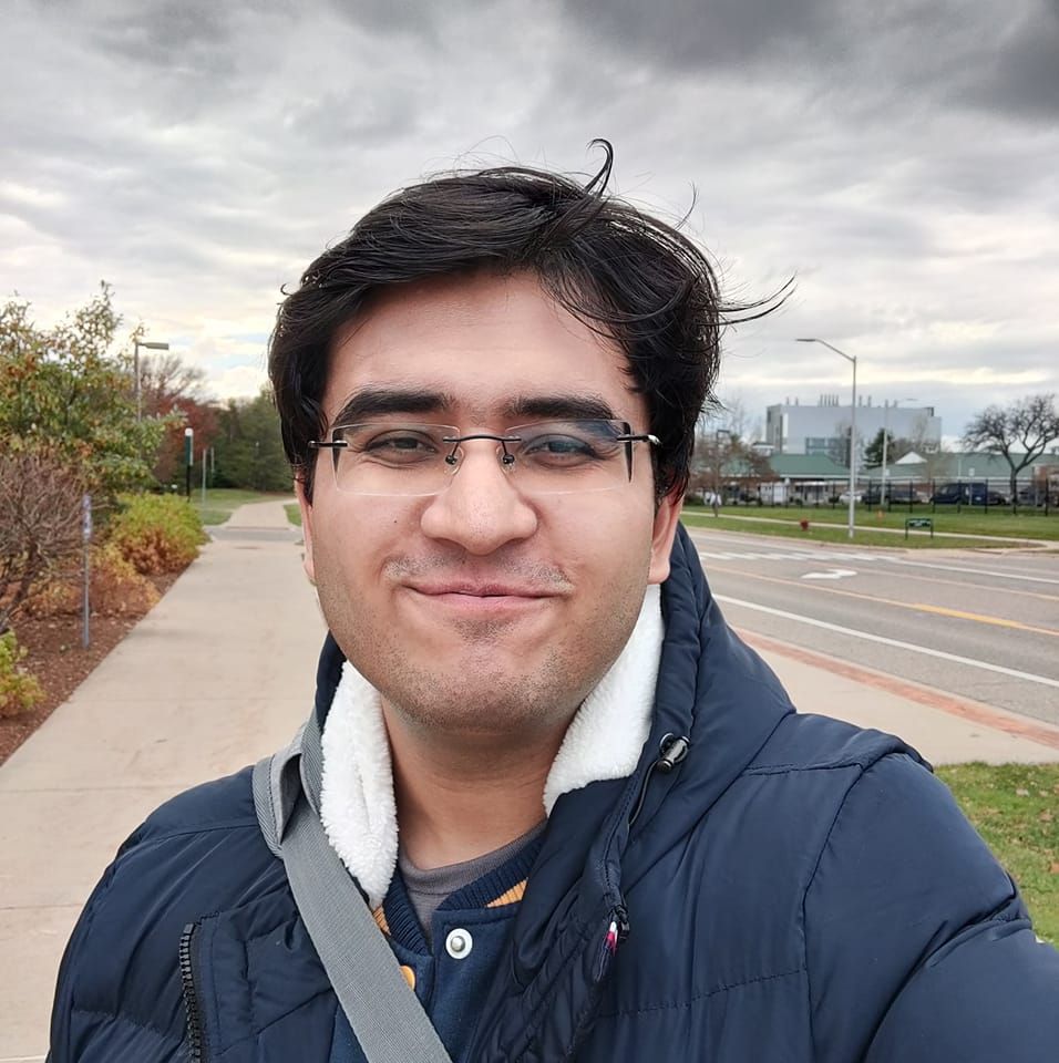 Picture of site owner with glasses and a puffer coat against a grey sky.